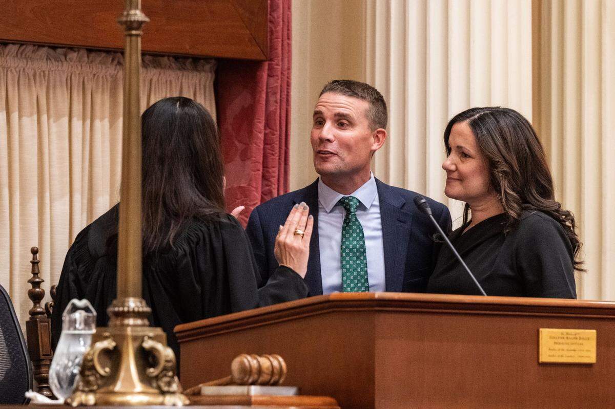 Senate President pro Tem Mike McGuire, D-Healdsburg, is sworn in by California Supreme Court Chief Justice Patricia Guerrero with his wife Erika on Monday during the first day of session at the state Capitol.