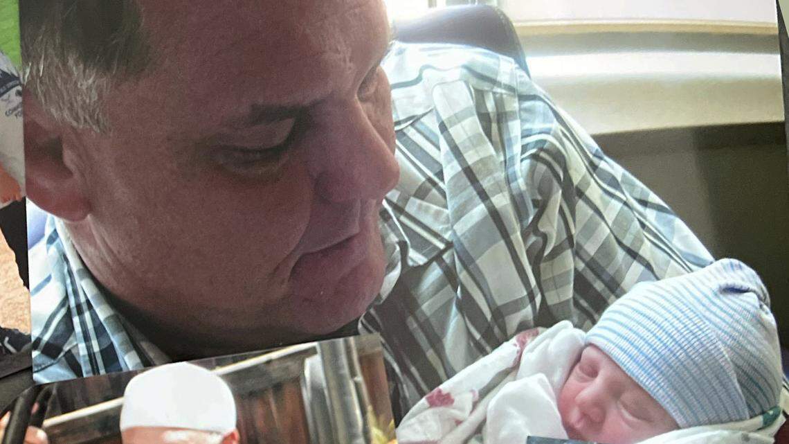 In this undated photo provided by Kenda James, Kevin Dizmang holds his granddaughter as an infant.