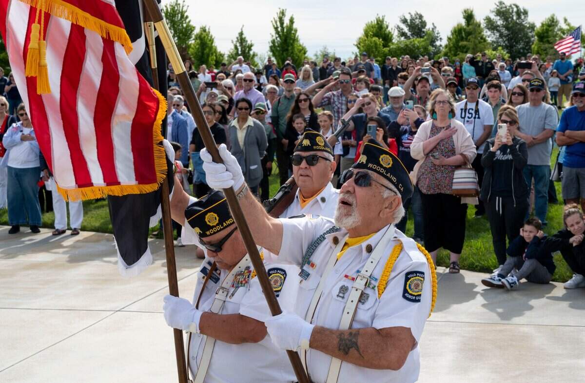 Members of the American Legion Yolo Post 77, John Flores, left, Leslie Murillo and Vince Olvera, right, perform the Retiring of Colors during the Memorial Day ceremony at the Sacramento Valley National Cemetery in Dixon on Saturday.