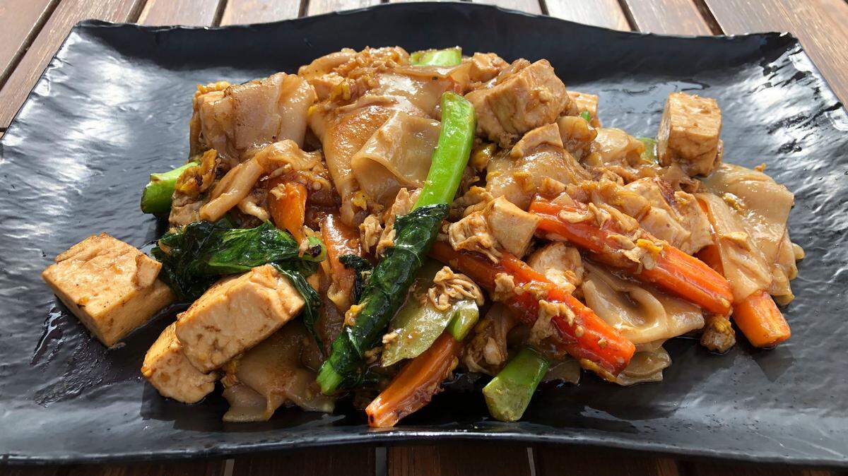 Pad See Eiw from The House of Authentic Ingredients is made with your choice of protein stir-fried with wide rice noodles, Chinese broccoli, carrots and egg.