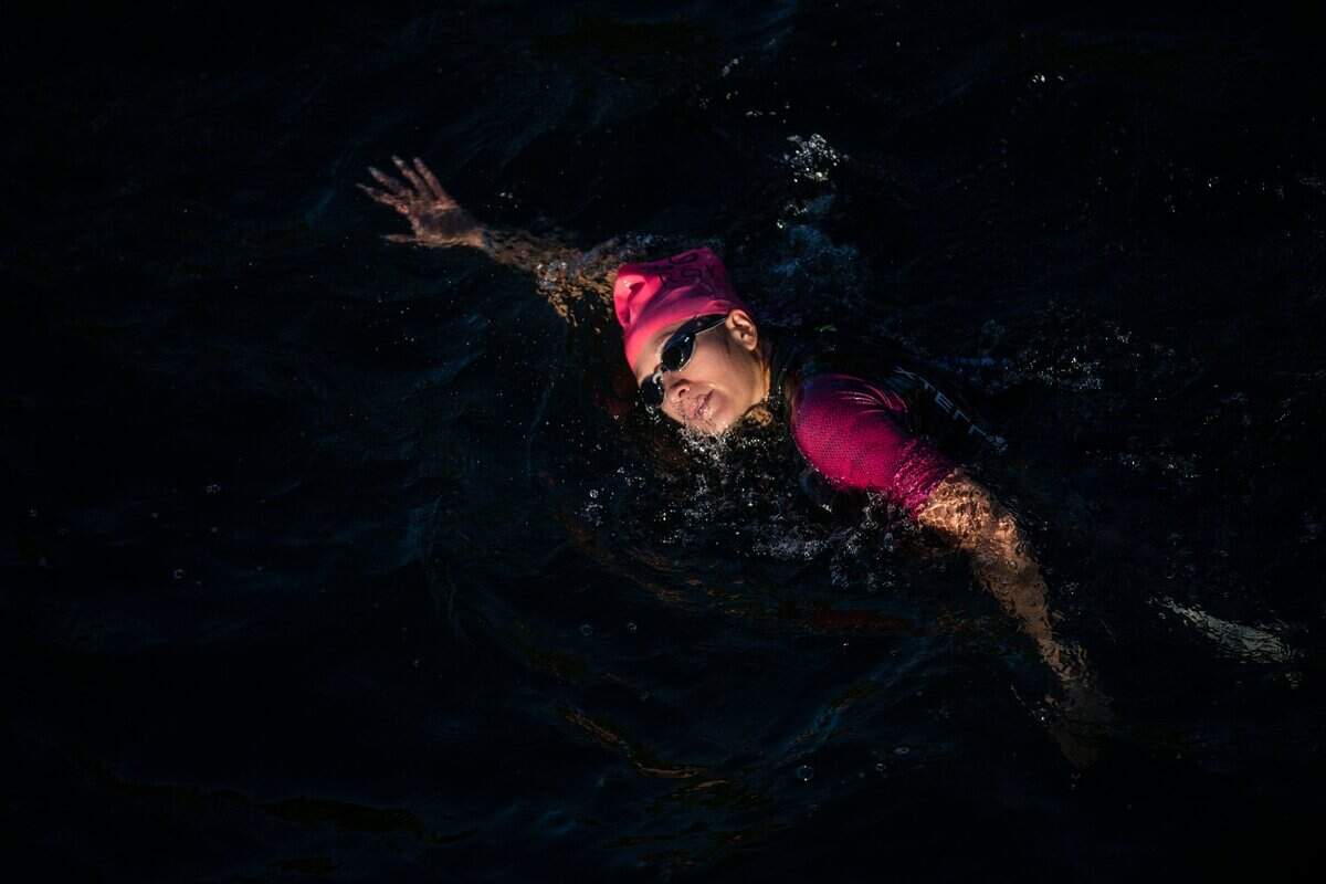 Emily Hoy of Waynesboro, Va., swims on the American River during the Ironman California triathlon in Sacramento on Sunday, Oct. 23, 2022.