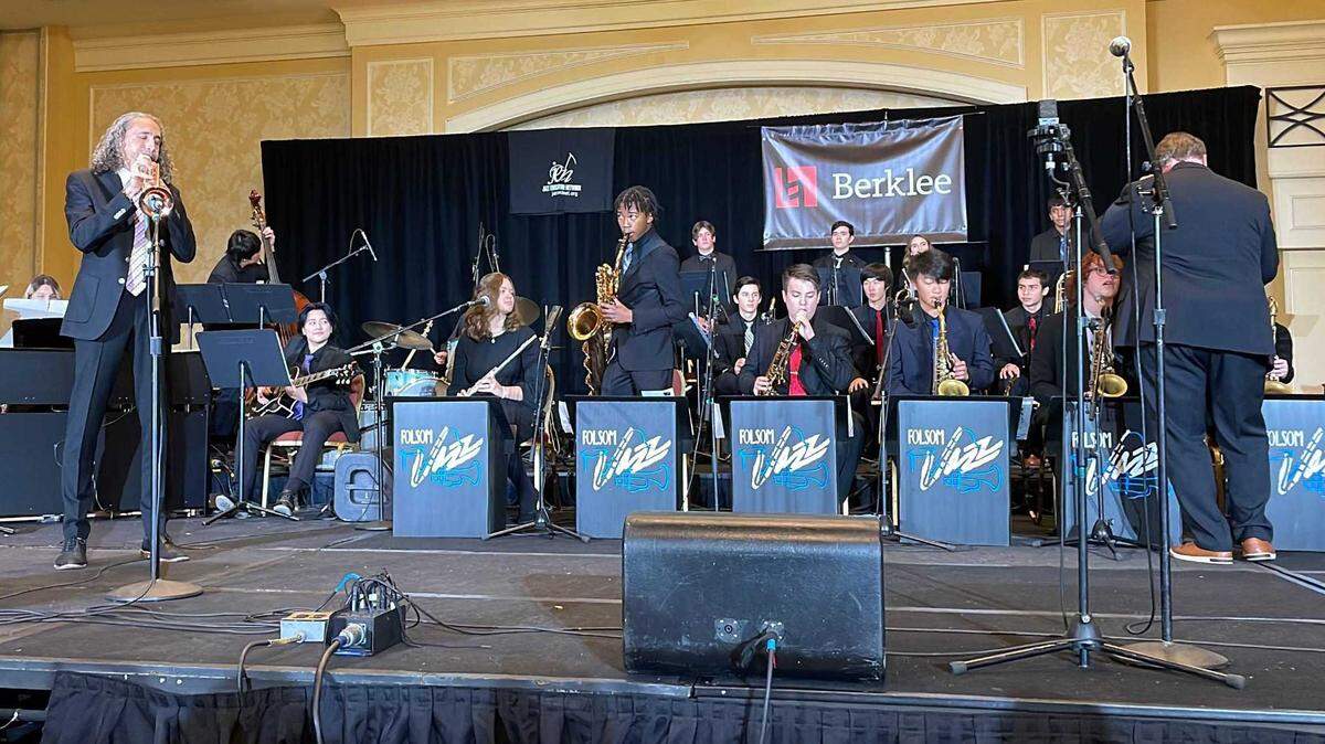 John Daversa, left with trumpet, warms up “You Think You’re Funny” with the Folsom High School jazz band as director Curtis Gaesser, right, watches just before their concert together on Jan. 7, 2023. Gaesser said he retires at the end of the 2022-2023 school year because he is “tired inside” and wants to spend time with his wife.