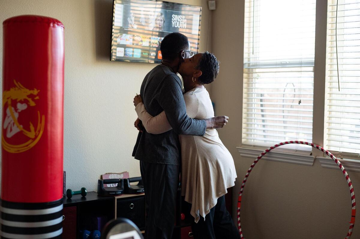 Carla Preyer leans in to hug her husband, Patrick Preyer, who has Lewy body dementia, in a part of their home dedicated for gym equipment and exercise Wednesday, Feb. 24, 2021, in Rancho Cordova. “When he and I work out together, the days are much better – for him and me,” Carla said. Lewy body dementia is a progressive form of dementia that affects a person’s cognitive abilities and movement.