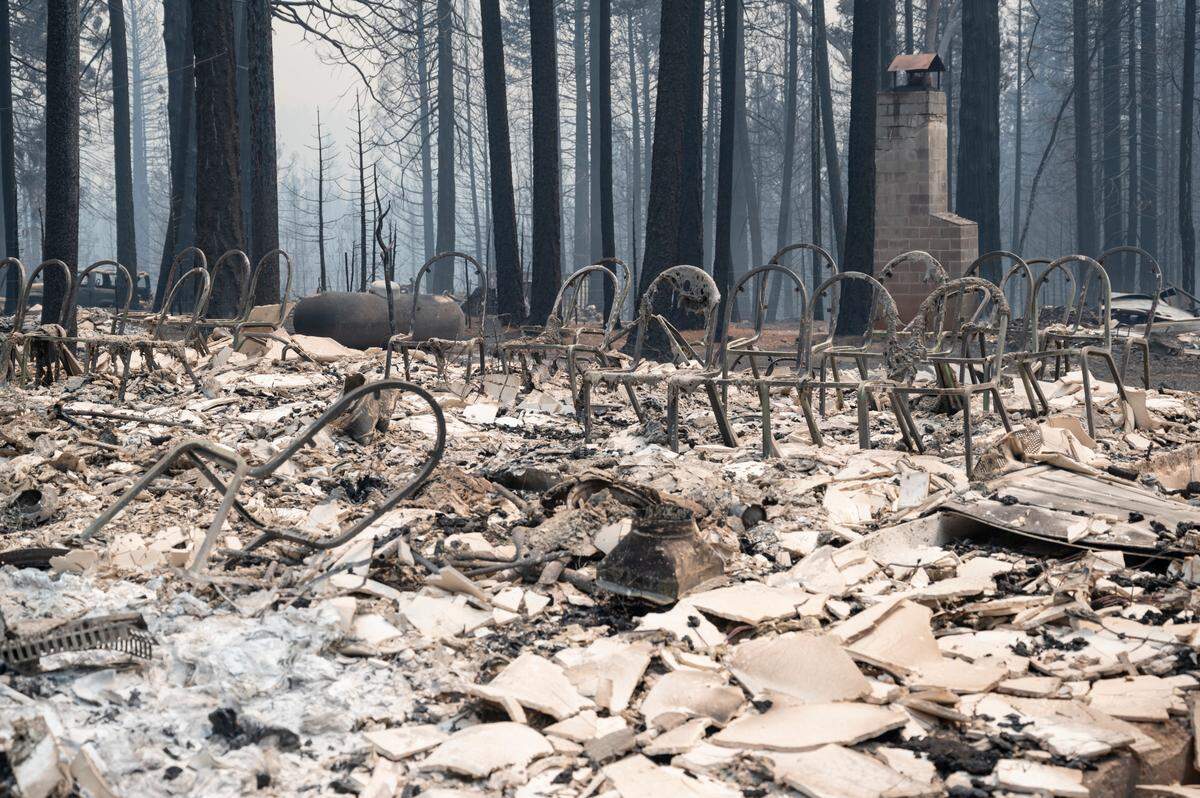 The frames of the chairs and the chimney are the only things that remain at the Grizzly Flats Community Church on Tuesday after the Caldor Fire raged through Grizzly Flats.