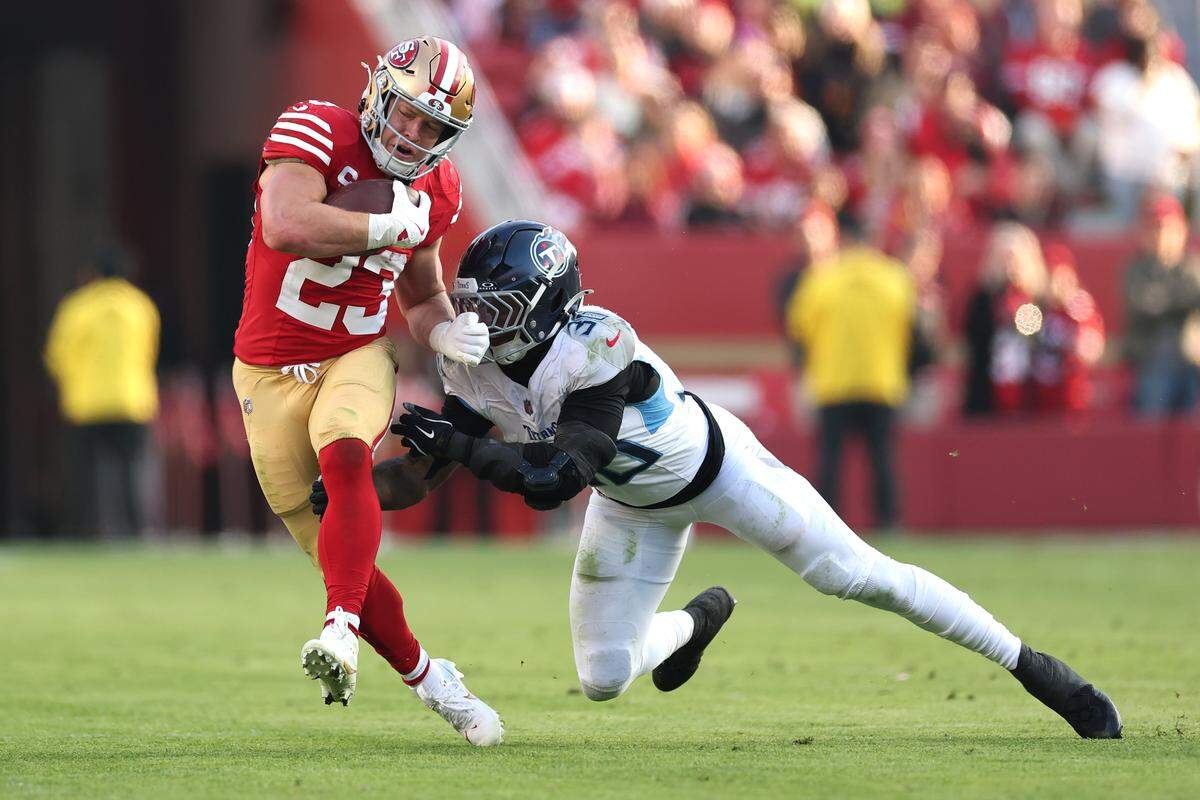 Christian McCaffrey, No. 23, runs with the ball against Kendell Brooks of the Tennessee Titans during the third quarter at Levi's Stadium on December 14, 2025 in Santa Clara. 