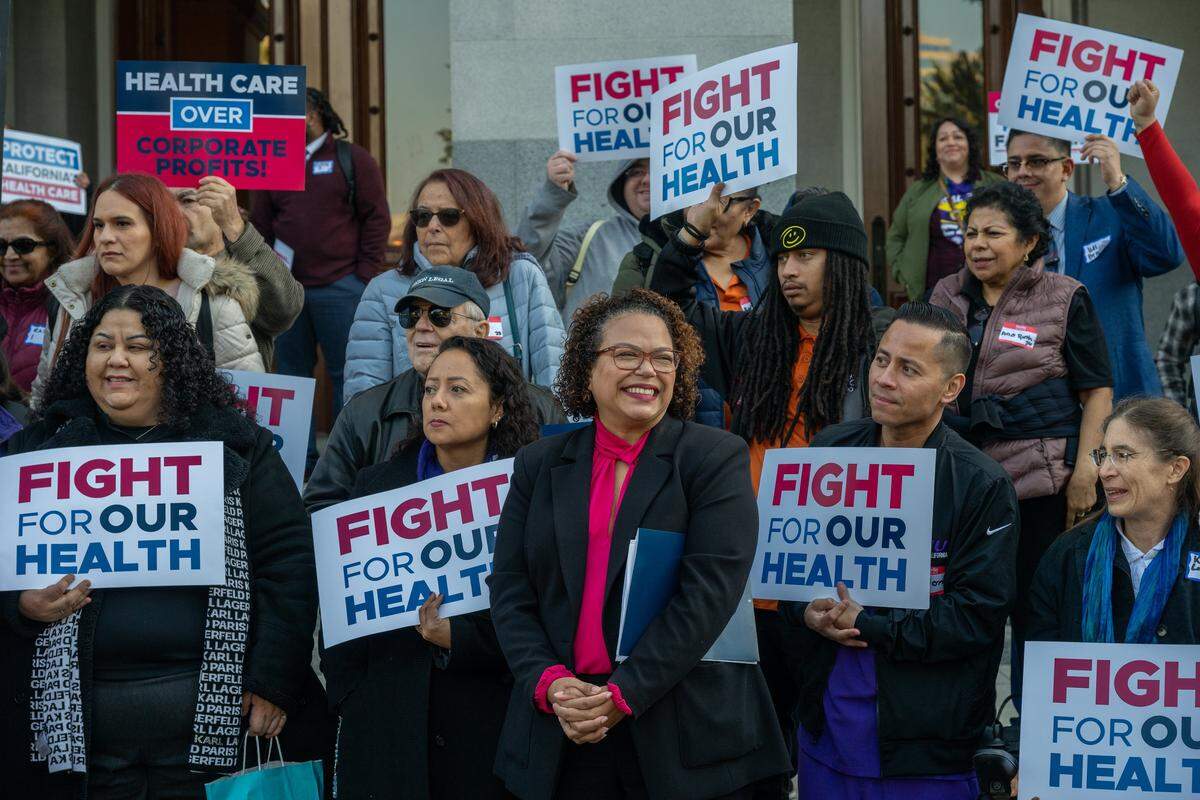 Assemblymember Mia Bonta, chair of the Assembly Health Committee, center, smiles after speaking at a “Fight for Our Health” rally at the state Capitol on Jan. 14 in Sacramento. “I’m here today because we know that California is on the brink of a public health emergency,” said Bonta.