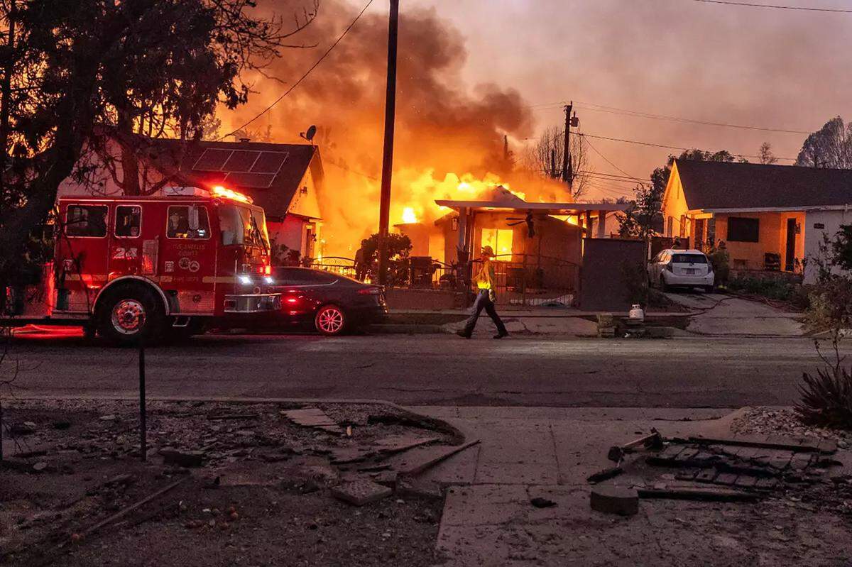 Flames from the Eaton Fire consume a home in Altadena on Wednesday, Jan. 8, 2025.