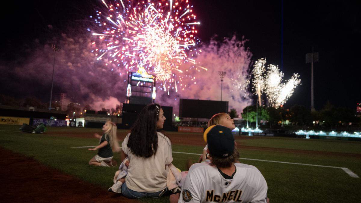 Athletics second baseman Jeff McNeil watches fireworks with his family following the home opener victory Friday over the Houston Astros at Sutter Health Park in West Sacramento.