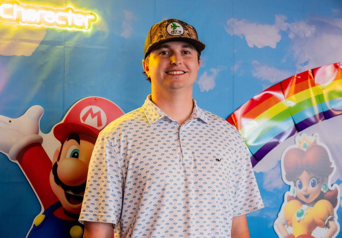 Jett Bonanno stands proudly in front of Super Mario Bros. decor that lines the walls of his bar, Jet’s, on Monday for the theme of the month.