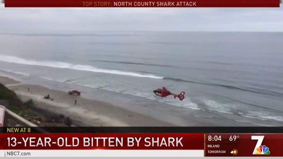 A helicopter lands Saturday morning on Beacon’s Beach near Encinitas, California, to take a 13-year-old boy injured in a shark attack to a hospital. The boy is in critical condition.