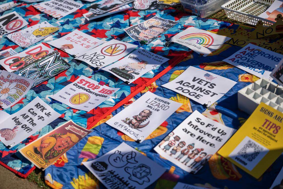 Signs lay out on a blanket in front of the state Capitol for demonstrators to take during the No Kings protest against President Donald Trump in Sacramento on Saturday.
