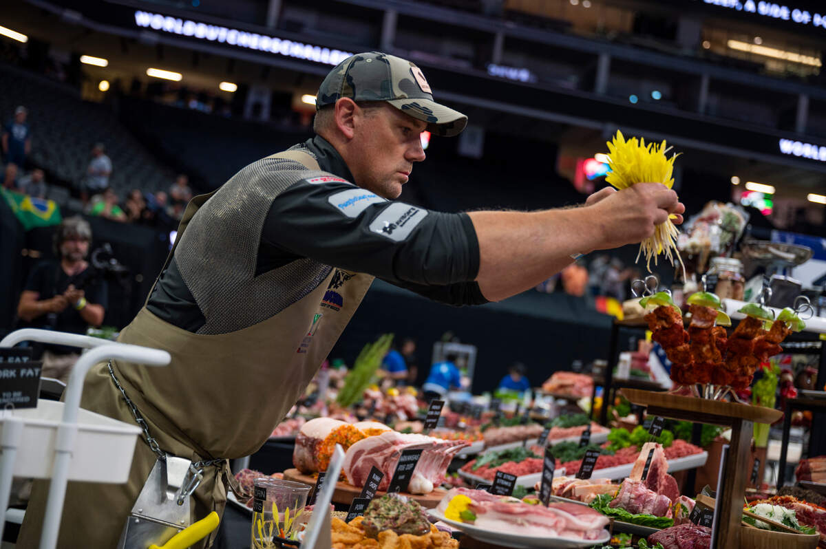 Paul Carras, of Taylor’s Market in Sacramento, puts the finishing touches on the American team’s presentation at the World Butchers’ Challenge at Golden 1 Center in Sacramento on Saturday, Sept. 3, 2022.