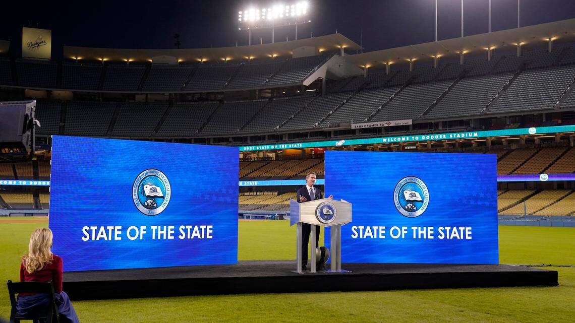 California Gov. Gavin Newsom delivers his State of the State address from Dodger Stadium as his wife Jennifer Siebel Newsom listens Tuesday, March 9, 2021, in Los Angeles. (AP Photo/Mark J. Terrill)