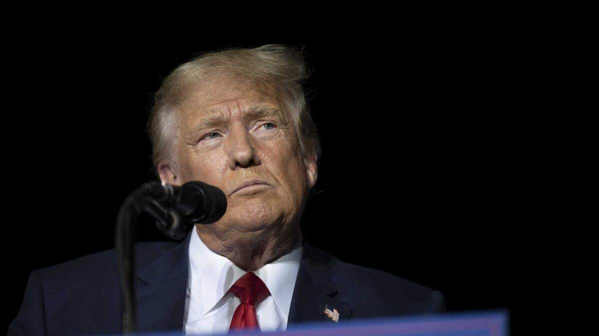 Former President Donald Trump pauses Saturday while speaking at a rally at the Minden Tahoe Airport in Nevada.