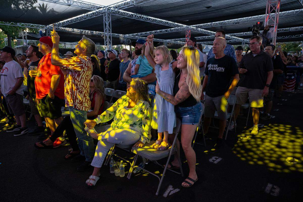 Taylor Winter of Sacramento dances with her daughter Tinsels, 6, as Tesla performs at the California State Fair in Sacramento on Friday.