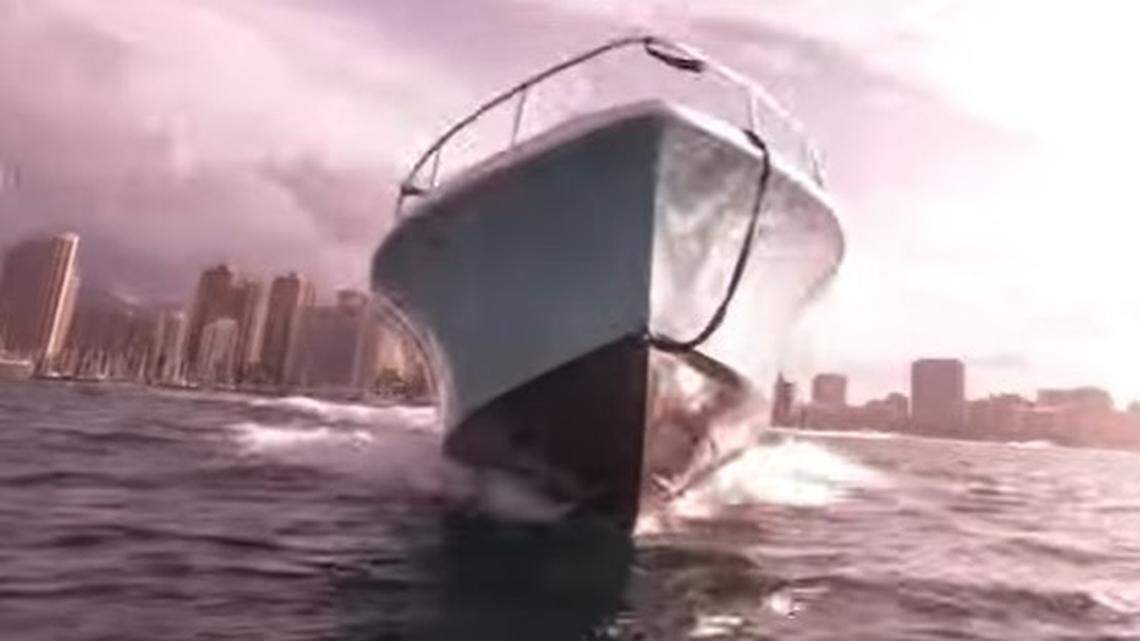 A video shot by a diver in Hawaii shows his narrow escape from an oncoming boat when he surfaced at the wrong moment.