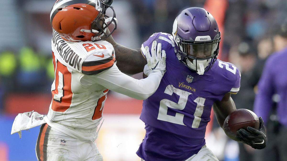 Minnesota Vikings running back Jerick McKinnon (21) runs with the ball as Cleveland Browns safety Briean Boddy-Calhoun (20) defends during the second half of an NFL football game at Twickenham Stadium in London on Sunday, Oct. 29, 2017.