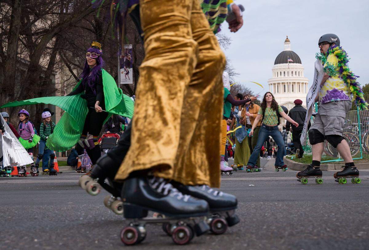 SacQuadSquad roller skaters lead the City of Trees Parade Mardi Gras procession west on Capitol Mall on Saturday, Feb. 18, 2023, in downtown Sacramento.