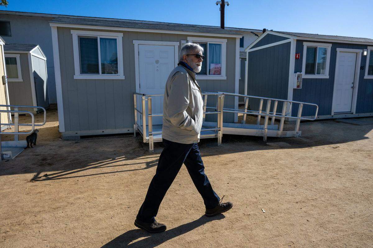 Stephen Watters, executive director of First Step Communities, walks through The Grove tiny cabin community for homeless young people age 18-24 in North Sacramento on Wednesday. The shelter site is launching an “adopt a cabin” fundraising effort. Its of 50 tiny cabins can house two people if necessary. The program provides housing and services that help youth with education, jobs, therapy and housing.