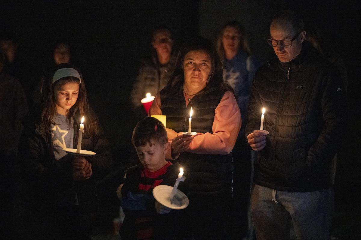 Neighbors pray during a vigil on Mill Water Circle in Rancho Cordova on Sunday, Feb. 1, 2026, to remember the Vallerga family who were found dead in their home on the street on Jan. 27 in an apparent murder-suicide.