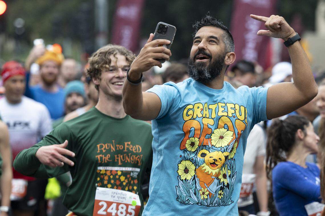 Race participants get hyped up before the start of the 10k race during the Run to Feed the Hungry in Sacramento on Thursday, Nov. 27, 2025.
