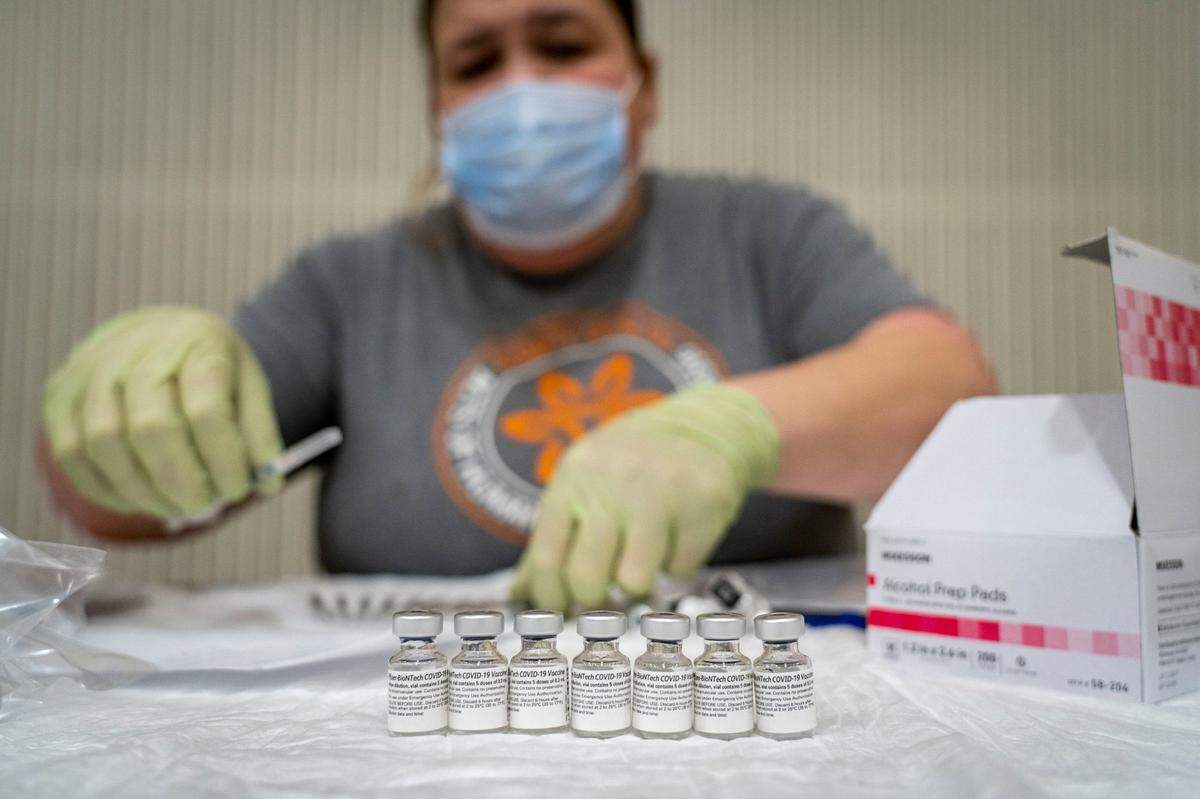 Mercy Health employee Kelley Williams prepares doses of the Pfizer COVID-19 vaccine for use, Saturday, Feb. 20, 2021, at Del Campo High School in Fair Oaks during a vaccine clinic held by the San Juan Unified School District in partnership with Dignity Health. The clinic is expected to vaccinate 2000 district employees and community members over 65.