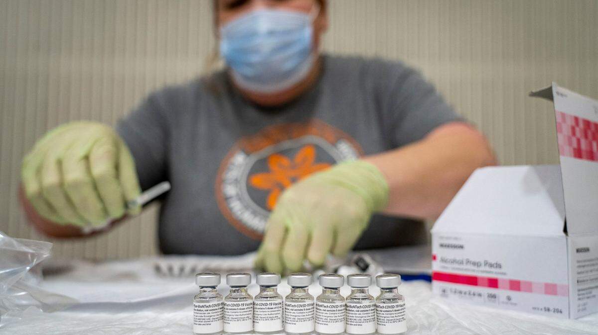 Mercy Health employee Kelley Williams prepares doses of the Pfizer COVID-19 vaccine for use, Saturday, Feb. 20, 2021, at Del Campo High School in Fair Oaks during a vaccine clinic held by the San Juan Unified School District in partnership with Dignity Health.