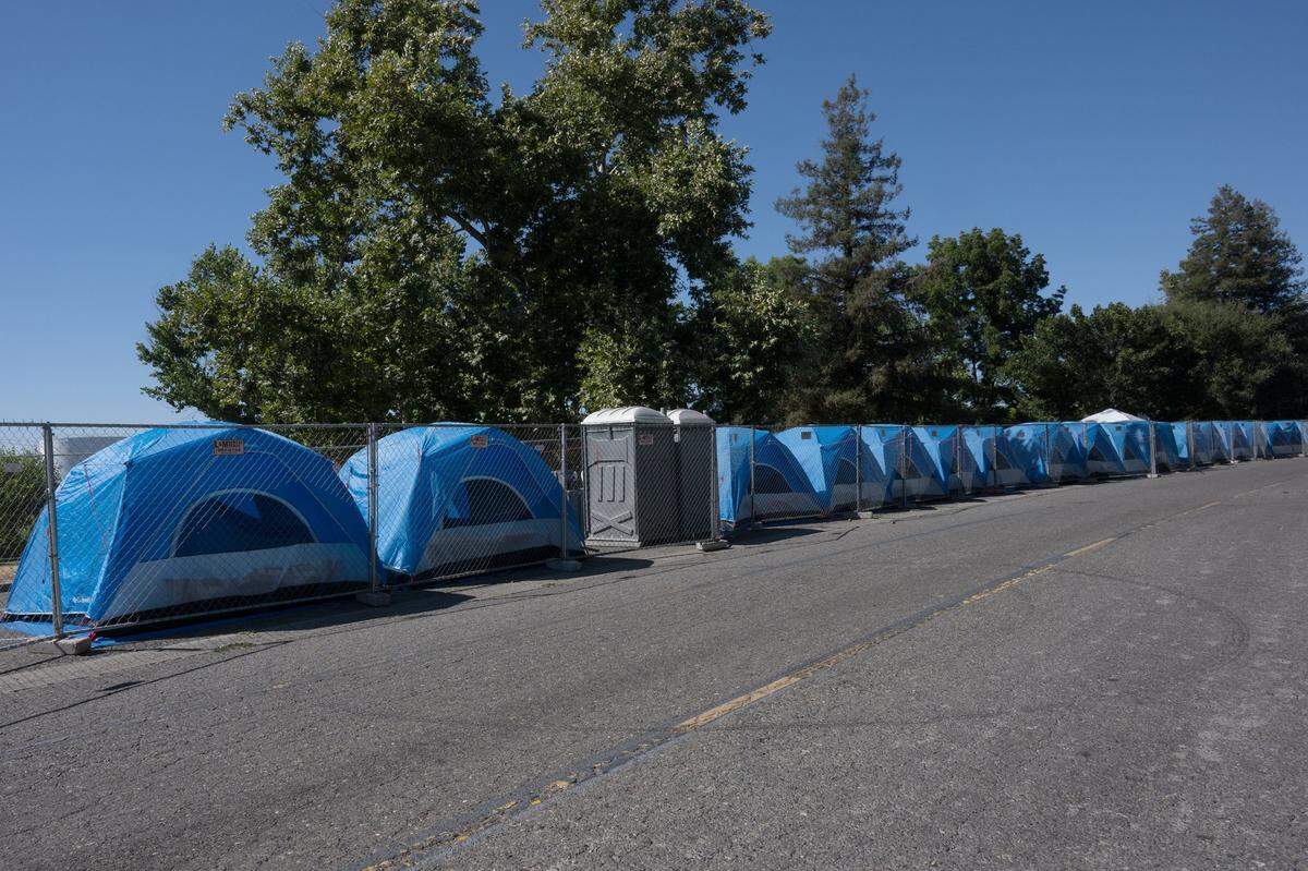 Tents bake in the afternoon sun as temperatures hit 91  degrees – cooler than many recent days –&nbsp;at the Safe Ground at Miller Park in Sacramento in August. Communities in partnership with the City of Sacramento. Homeless advocates say there is no protection from the extreme heat at the site because most of the tents are on hot asphalt in direct sunlight.