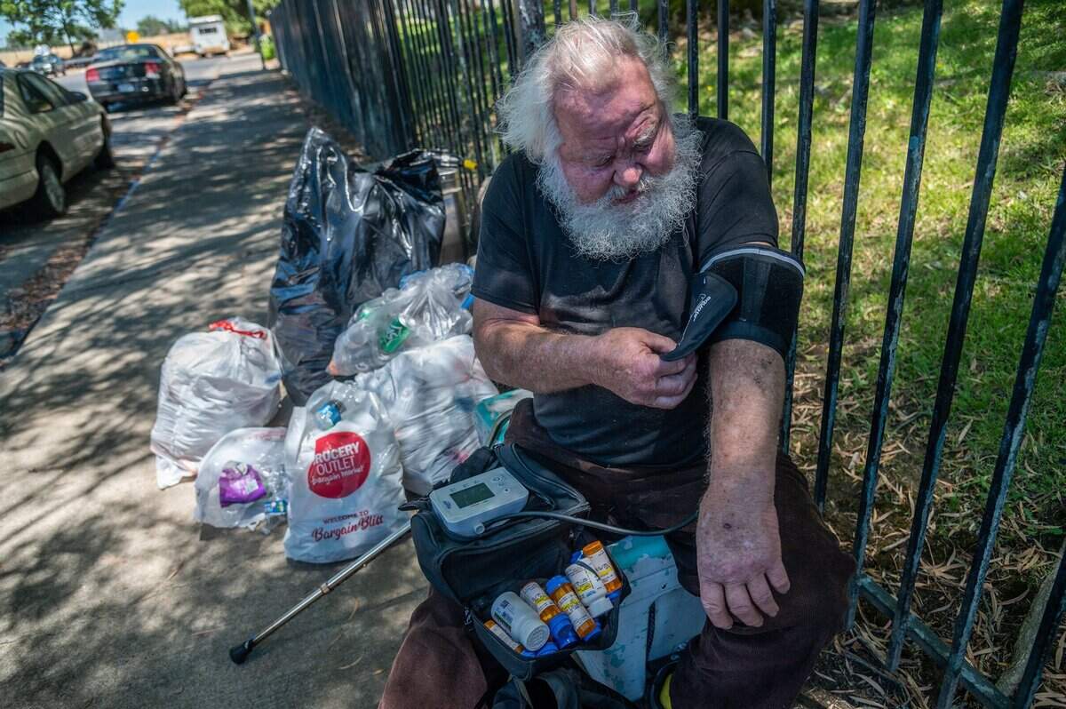 Donald Lowery, who was released from the hospital recently, balances his medicines as he checks his blood pressure on June 14, in Sacramento. “I was getting out of line and at 242, I was getting scared,” he said about his blood pressure. He is one of about 250 people that have been kicked out of the three Project Roomkey motels in Sacramento.