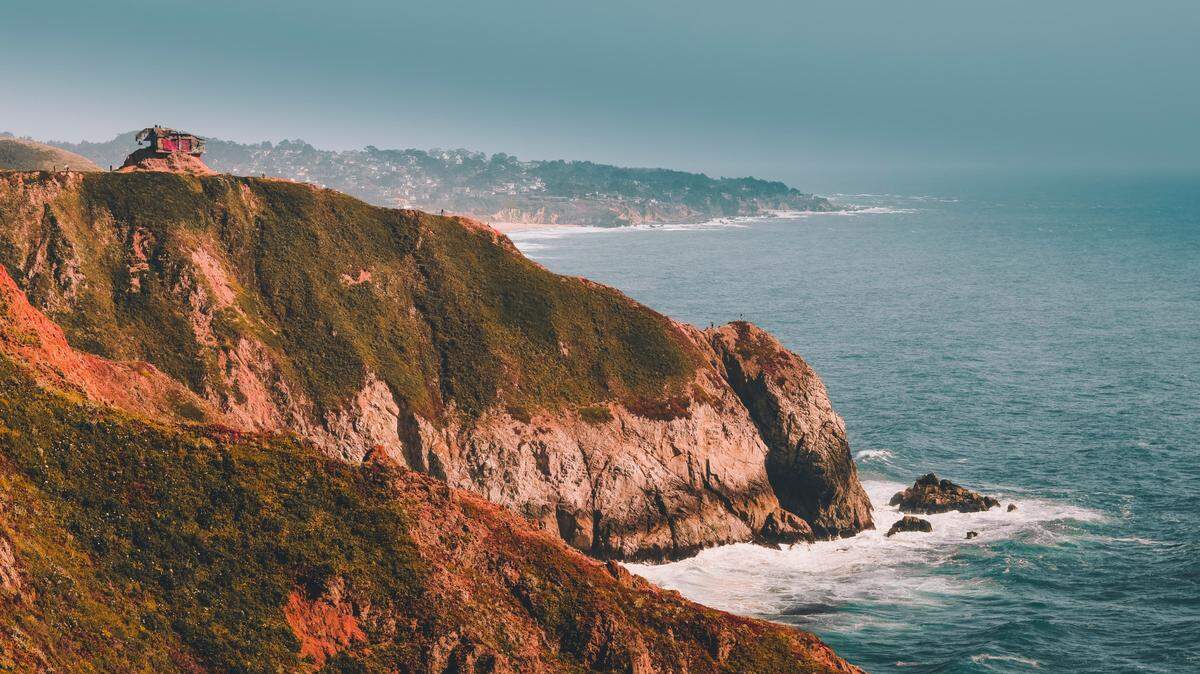 A beachgoer jumped into cold, choppy waters off a California beach trying to save two struggling surfers.