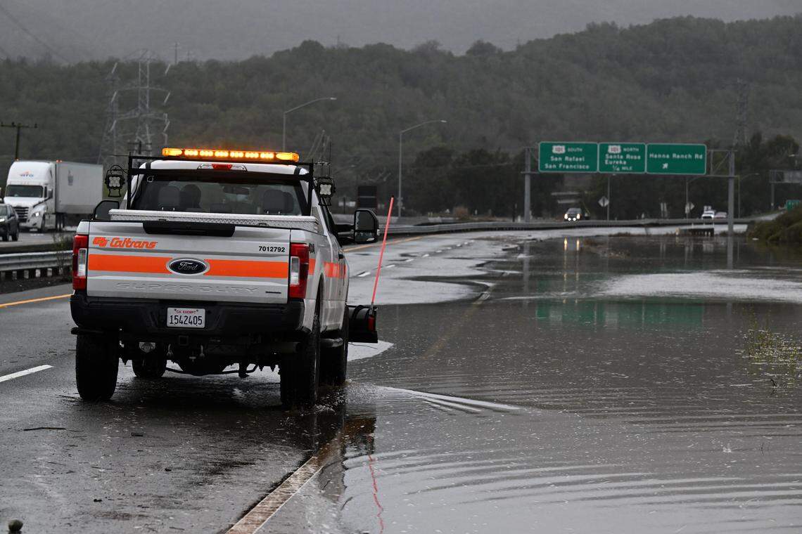 A Caltrans truck drives on westbound Highway 37 as water recedes near Novato in January 2023. The flooding followed a storm that temporarily shut down lanes, raising concerns among critics who argue the current project to elevate the expressway fails to address long-term sea level rise.