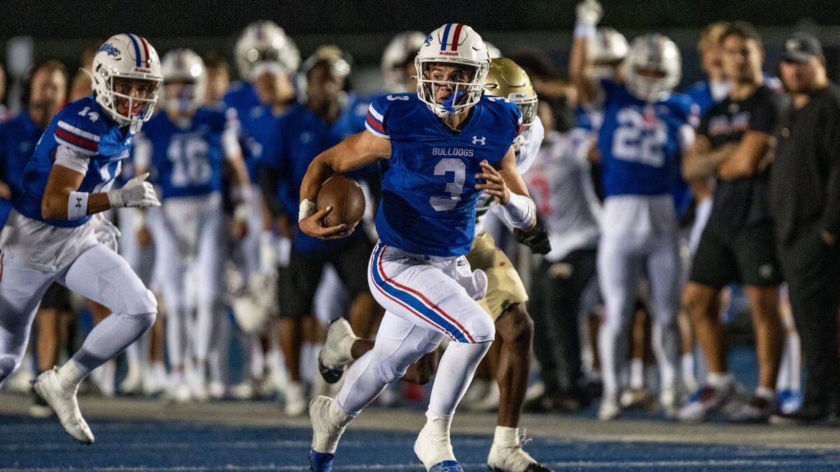 Folsom Bulldogs quarterback Ryder Lyons (3) scrambles for a long gain to put his team into position for another touchdown against the Long Beach Poly Jackrabbits on Friday. Lyons lost a fingernail on the play and had to be bandaged on the sideline before returning to the game.