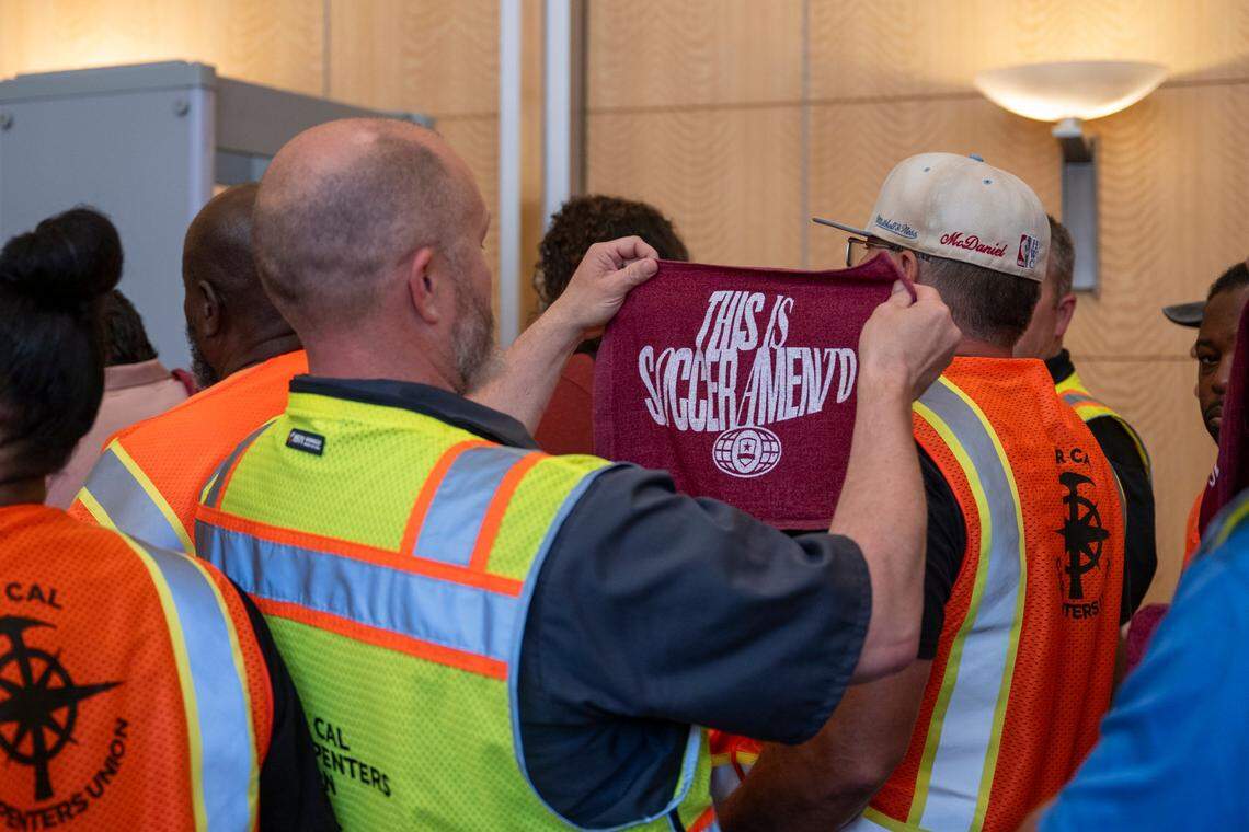 A member of Nor Cal Carpenters Union Local 46 looks at a Republic FC towel in the lobby of Sacramento City Hall lobby before a City Council meeting Tuesday to approve the expansion of the Railyards district, for a new soccer stadium for Republic FC.