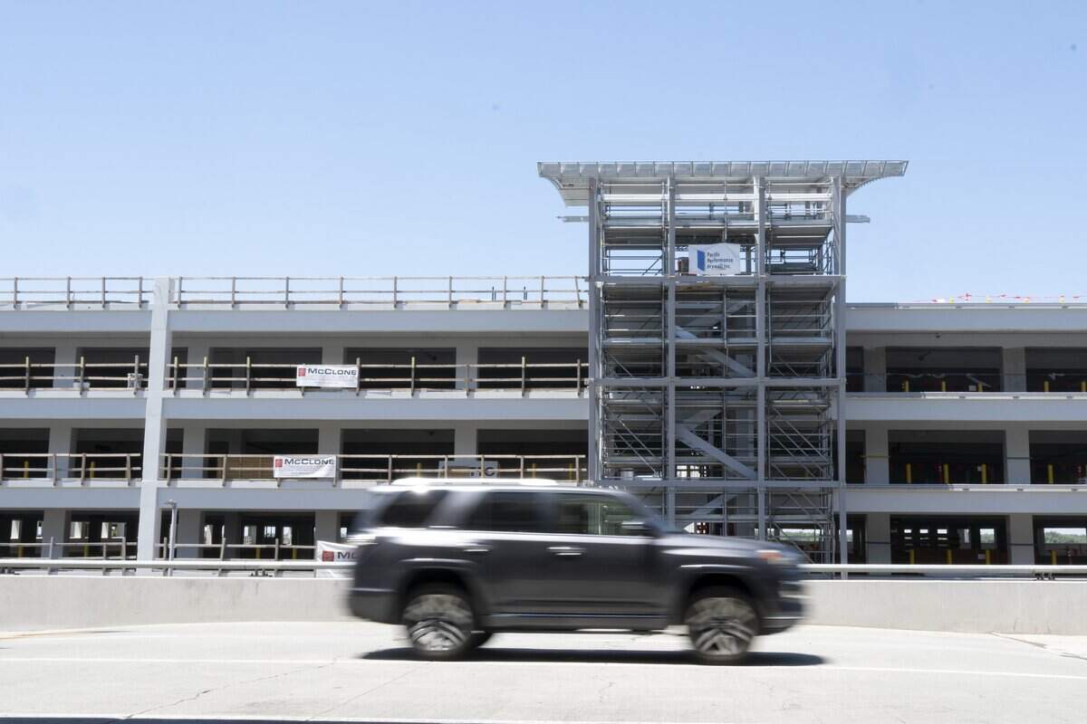 A car drives in front of the new parking garage currently under construction at Sacramento International Airport on Wednesday, June 17.