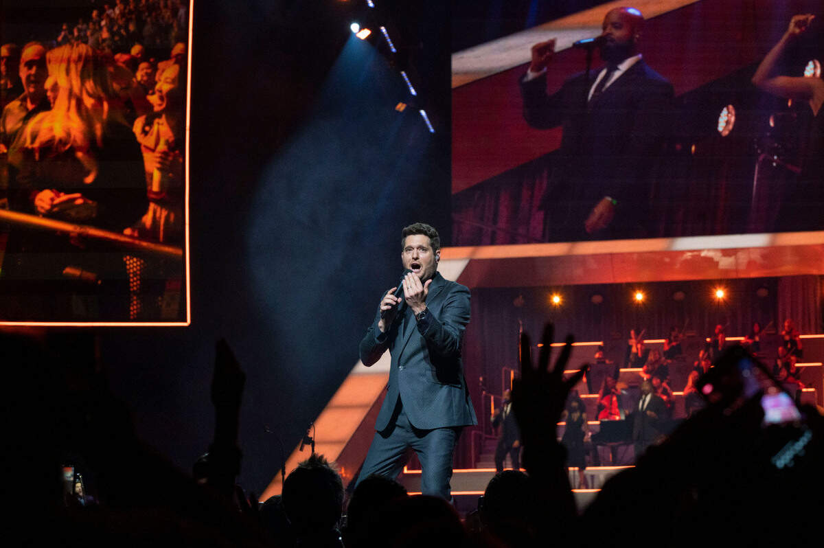 Michael Bublé fans are projected on a screen at left as he performs his Higher Tour at Golden 1 Center in Sacramento on Saturday.