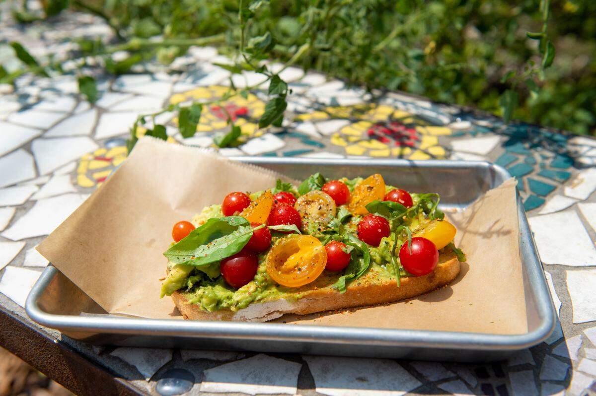 The avocado toast with fresh tomatoes and basil from the garden is served at Tree House Cafe in West Sacramento on Wednesday, Aug. 11, 2021.