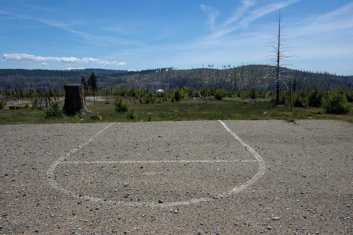 The basketball court is all that remains at Walt Tyler Elementary School, which served around 30 students and was burned the 2021 Caldor Fire.