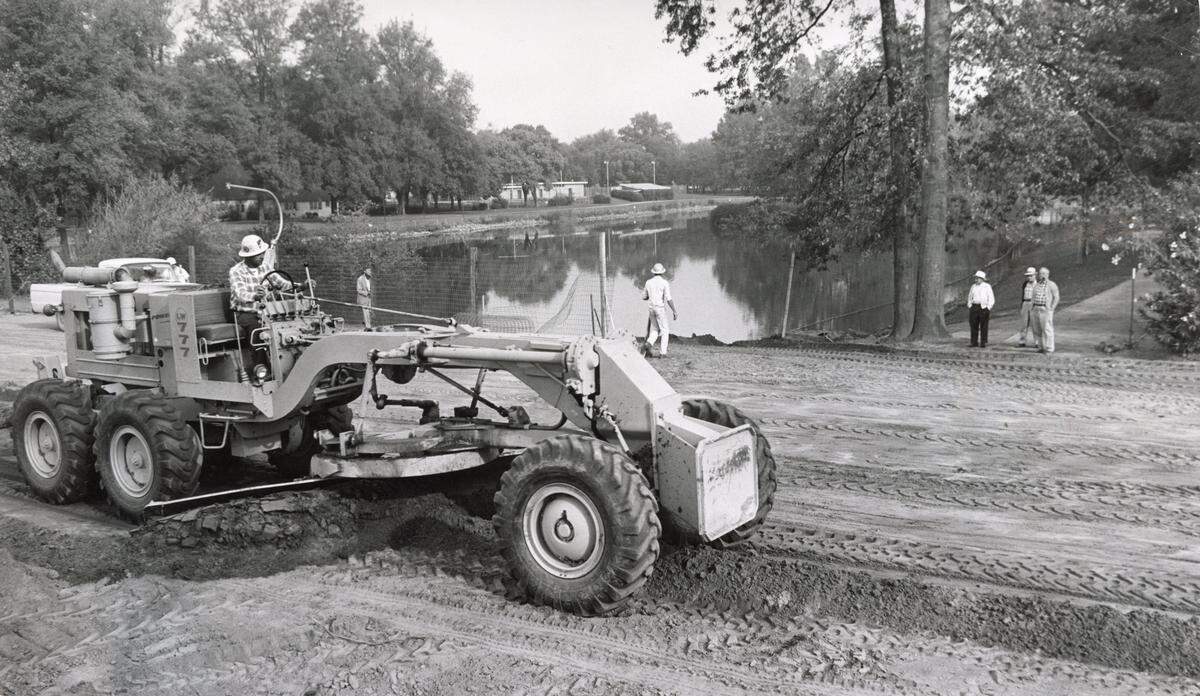 A grader fills in a portion of Southside Park's lake in Sacramento in 1965 as part of the W-X freeway project, which extended W Street through the park. The state lopped off about 7 acres of the park to build Highway 50.