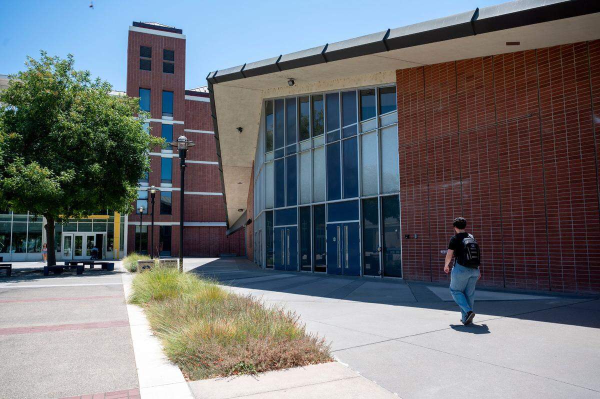 A student walks past Freeborn Hall at UC Davis last month. The building, which has housed the KDVS radio station in its basement for the past 60 years, is being demolished because it is considered seismically unsafe.