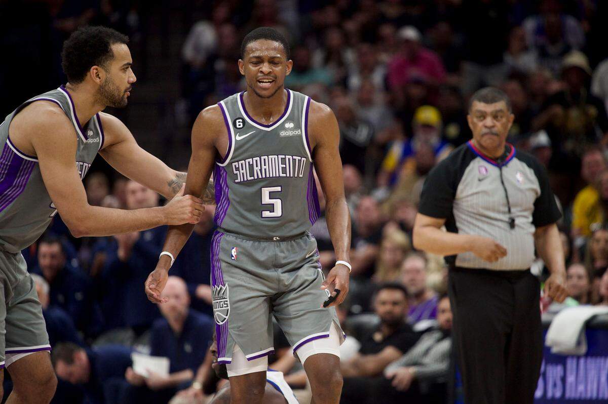 Sacramento Kings guard De’Aaron Fox (5) is supported by Trey Lyles as he reacts to being called for a foul against Golden State Warriors forward Draymond Green during Game 5 of the first-round NBA playoff series at Golden 1 Center on Wednesday.