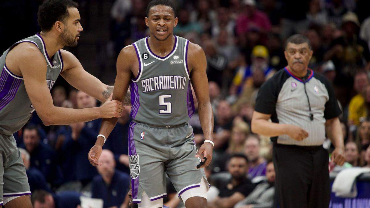 Sacramento Kings guard De’Aaron Fox (5) is held back by Trey Lyles as he reacts to being called for a foul against Golden State Warriors forward Draymond Green during Game 5 of the first-round NBA playoff series at Golden 1 Center on Wednesday.