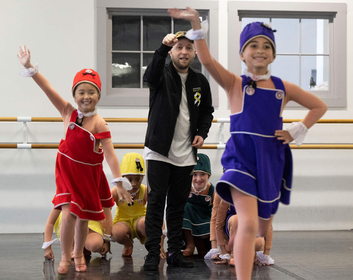Nutcracker youth cast members playing Mother Ginger’s children practice with Sacramento Ballet rehearsal director Colby Damon as they pretend to run out from underneath Mother Ginger’s skirt during a dress rehearsal in the midtown studios earlier this month. 