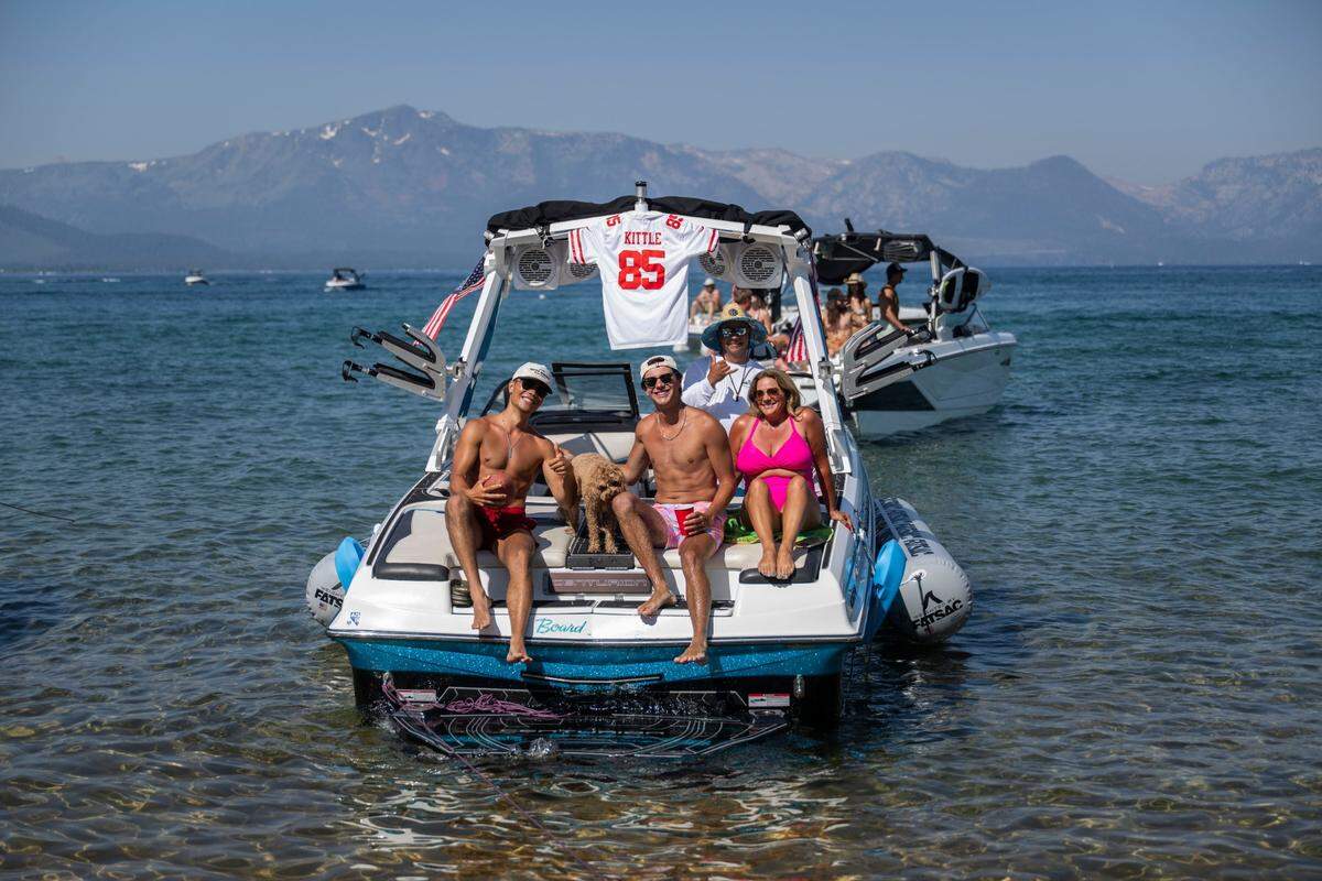 Lane Oliphant, left, of Reno, sits in the back of the family boat with his brother Mason and mother Brandy during the final day of the American Century Championship celebrity golf tournament at Edgewood Tahoe Resort in Stateline, Nev., on Sunday, July 13, 2025.
