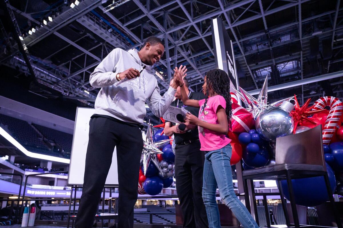 Sacramento Kings guard De’Aaron Fox, left, high-fives Monique, 7, of Leataata Floyd Elementary School, after a successful round of Pictionary during the “Eat Like a King” event for invited community members and groups serving underserved areas of the city Wednesday at Golden 1 Center. “We’re actually learning about basketball people in school,” said Monique “Our teacher, Ms. Vasquez, she used to be my sister’s teachers and she’s really fun, and she really understands me when I ask her for something or I need help.” The event is part of the organization’s 21st Annual Season of Doing Good, presented by Raley’s.