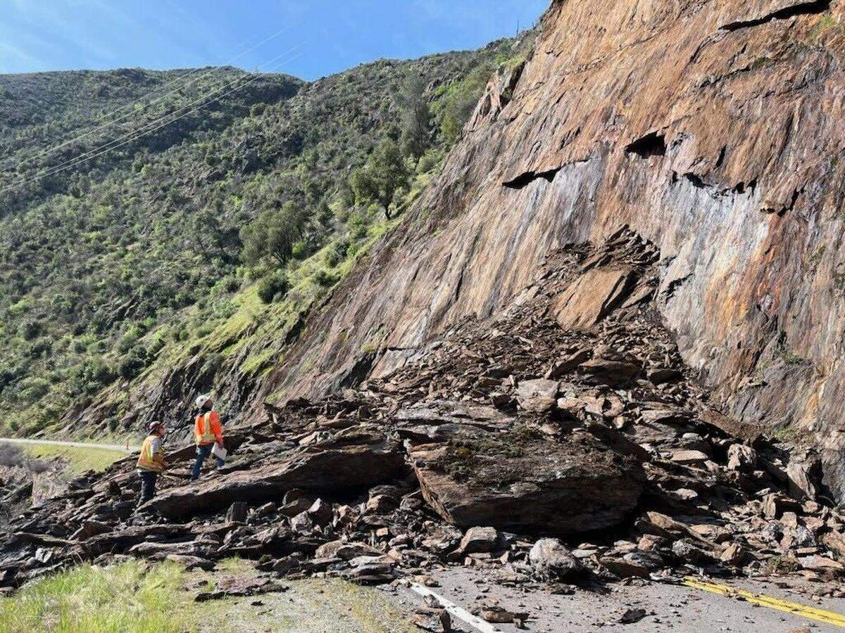 Workers inspect a debris slide that closed Highway 140 near the entrance to Yosemite National Park on Thursday, March 20, 2025.