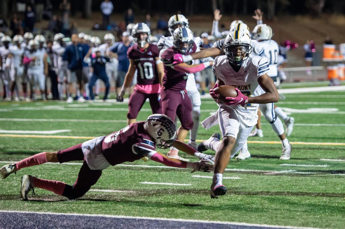 Rosemont’s Finis Mcdaniel jr. (16) runs the ball past Union Mine’s Cody Goehring (6) to score a touchdown during the fourth quarter in the game Friday at Union Mine High School in El Dorado. The Wolverines won 27-12.