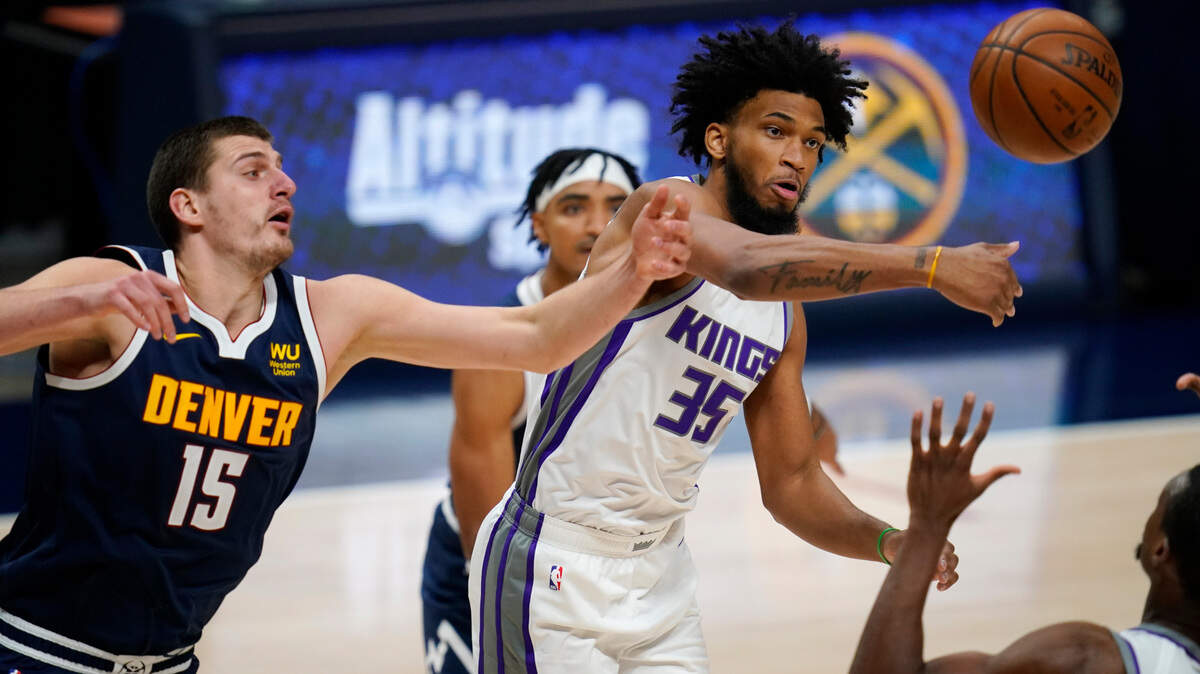 Sacramento forward Marvin Bagley III, right, battles for control of a rebound with Denver center Nikola Jokic on Wednesday night.