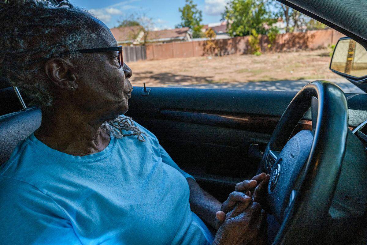 Wanda Clark, 72, looks out her car window at the empty lot where her home once stood in Oak Park on Tuesday. She said if she didn’t have a sister, she would be sleeping in her car, after the Bay Area Receivership Group caused her to demolish her home. Clark got to keep the land but she doesn’t have the money to rebuild.