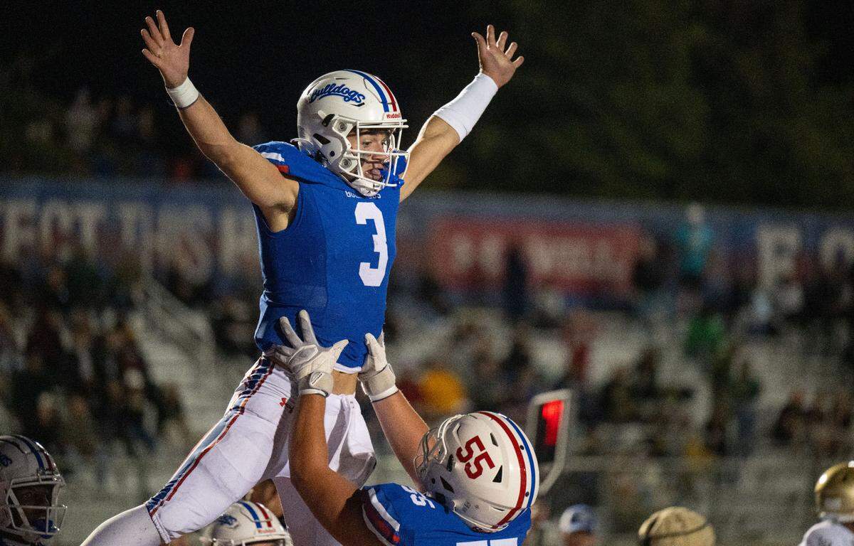 Folsom Bulldogs quarterback Ryder Lyons (3) celebrates with guard Luke Sorensen (55) after his 16-yard scramble into the end zone against the Long Beach Poly Jackrabbits on Aug. 23 in Folsom.