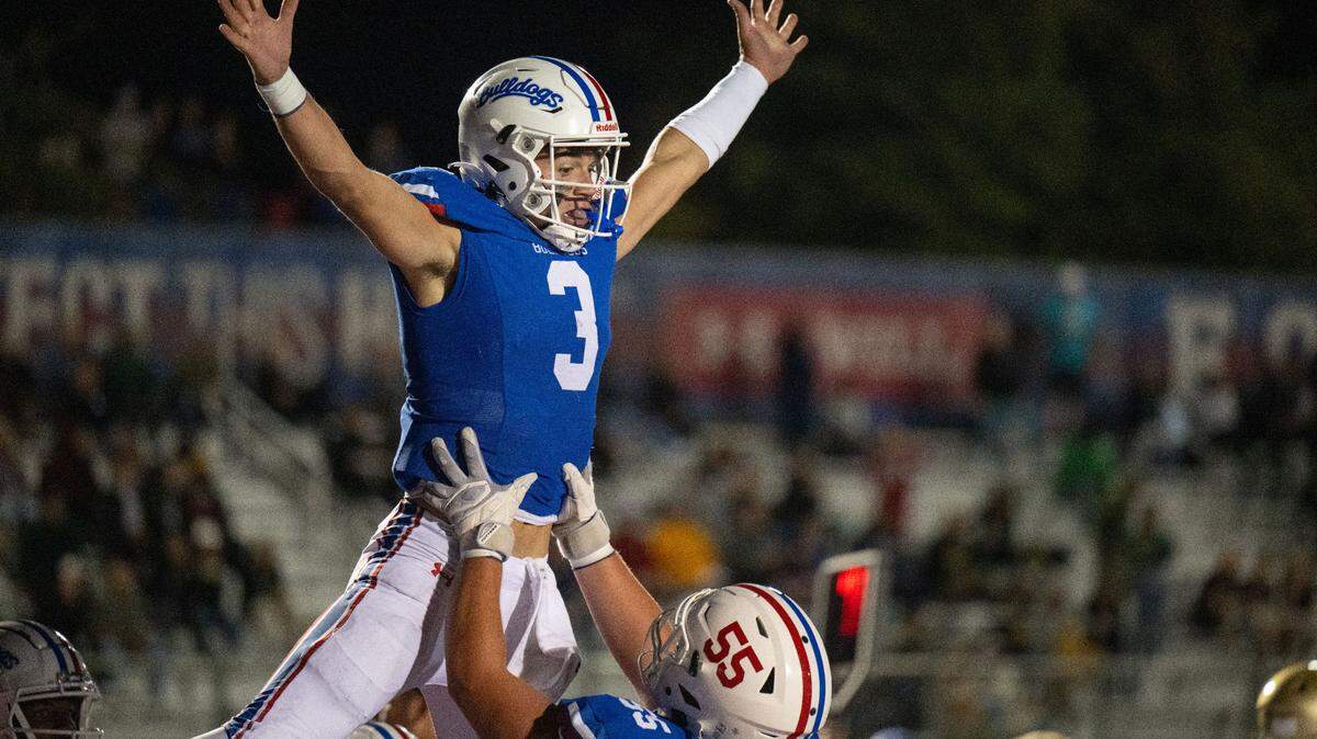 Folsom Bulldogs quarterback Ryder Lyons (3) celebrates with guard Luke Sorensen (55) after his 16-yard scramble into the end zone against the Long Beach Poly Jackrabbits on Aug. 23 in Folsom.
